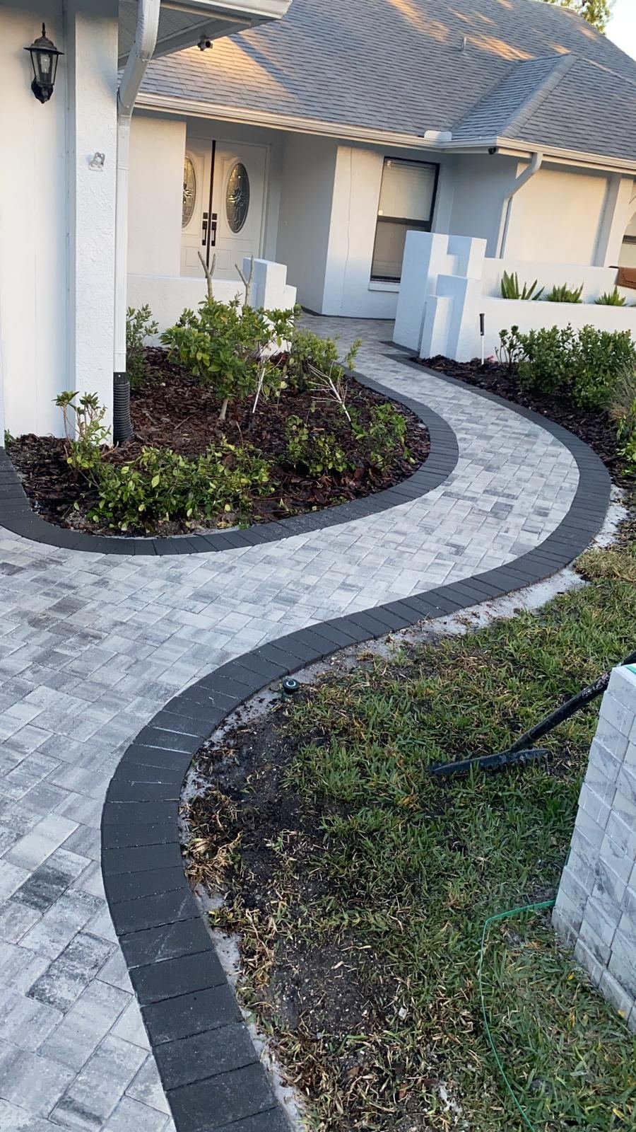 Curved paver walkway installation with border