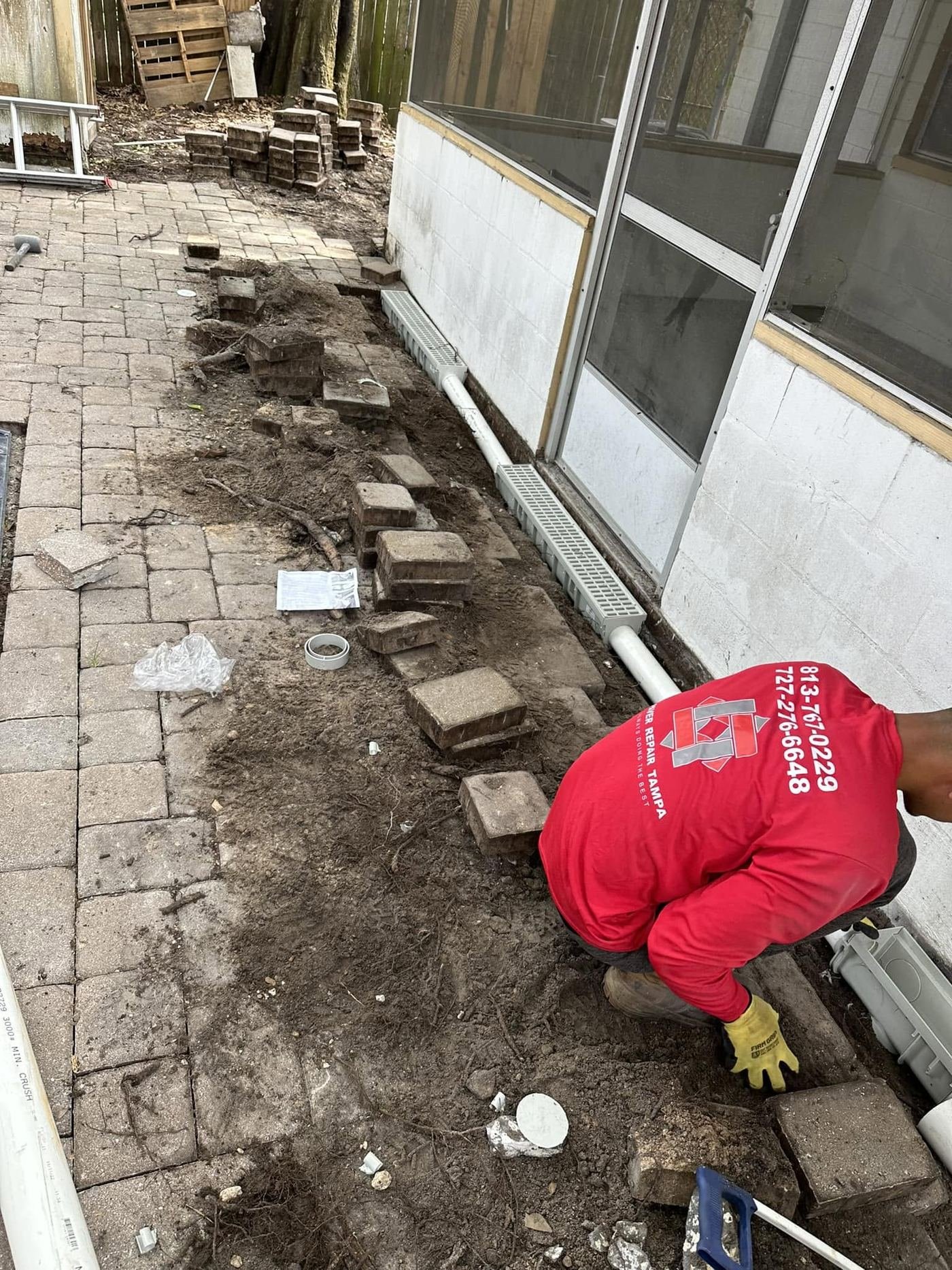 Drainage channel installation along walkway
