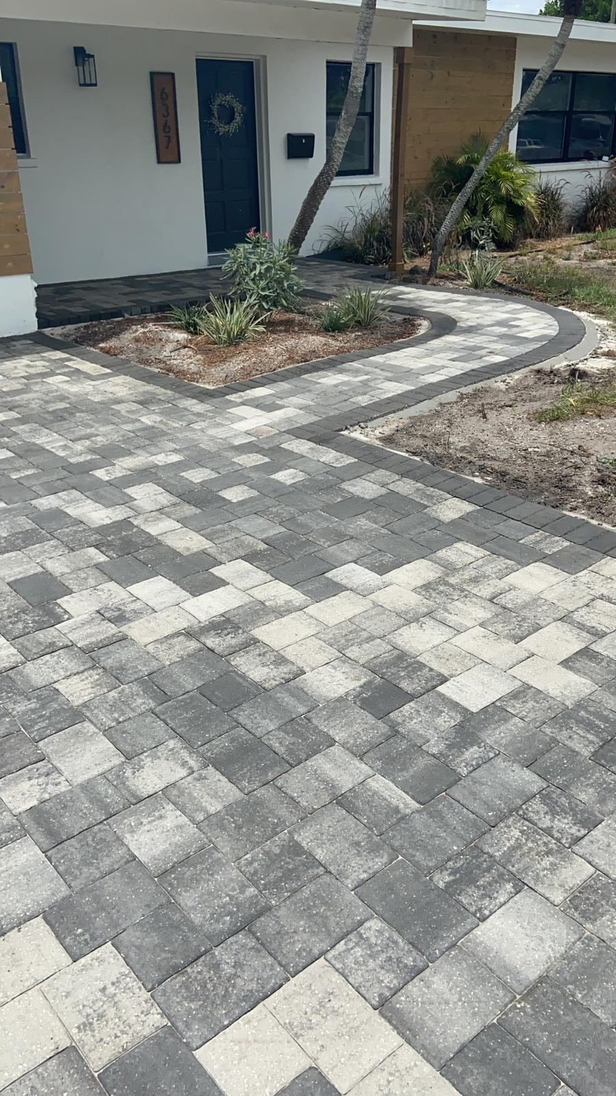 Charcoal and gray paver driveway with walkway