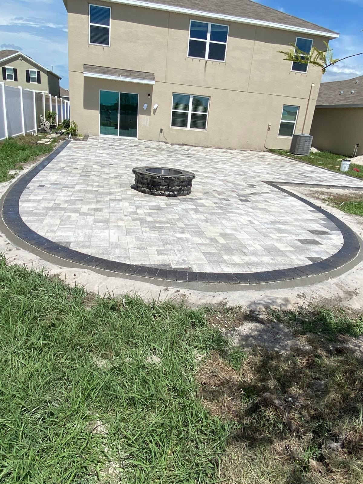 Round paver patio with firepit installation