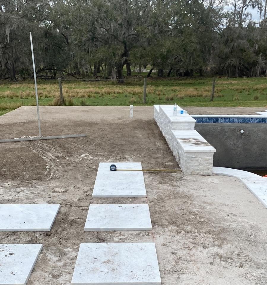 Backyard turf and paver installation before